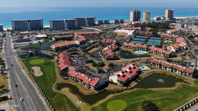 aerial overview of property's location with a large body of water, a local golf course, and nearby urban area
