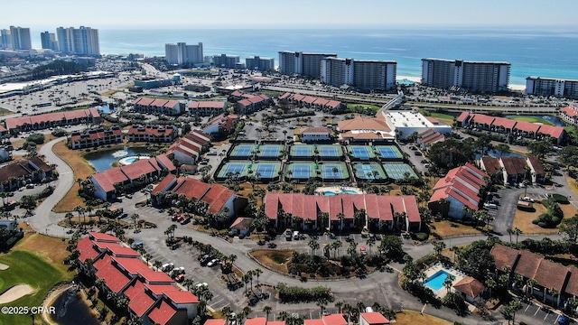 aerial view of property's location featuring nearby urban area, a nearby body of water, and a golf club