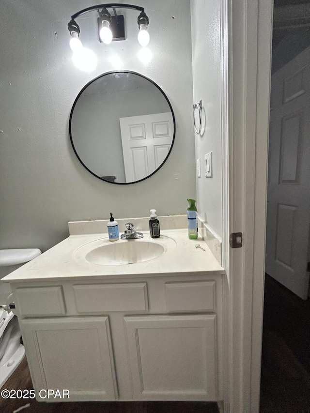 bathroom with toilet and vanity