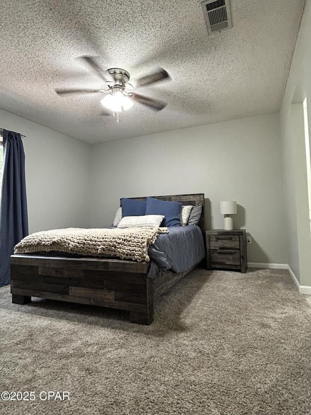 carpeted bedroom featuring baseboards, a ceiling fan, a textured ceiling, and visible vents