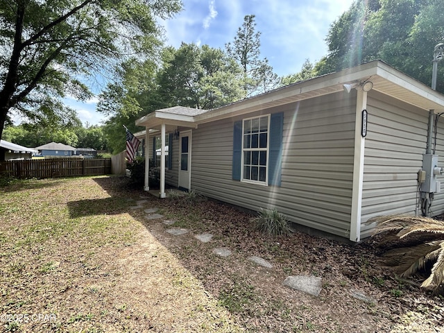 view of home's exterior featuring fence