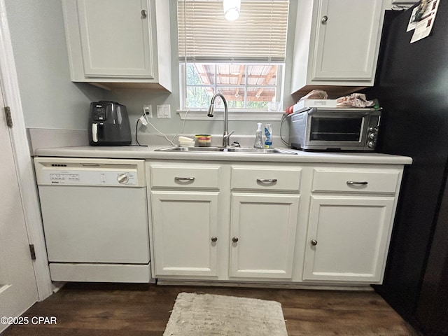 kitchen featuring a sink, white cabinets, a toaster, and dishwasher