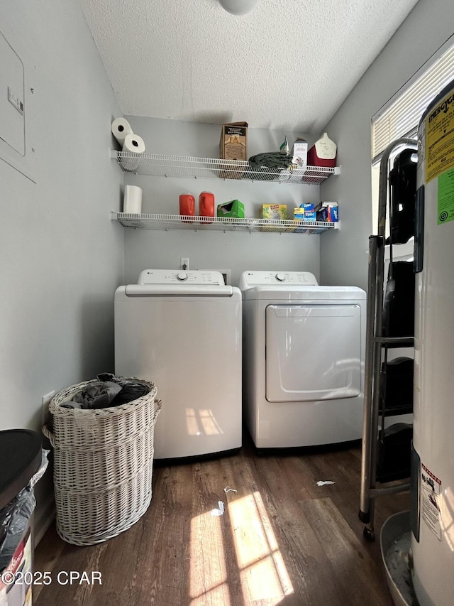 laundry area featuring a textured ceiling, laundry area, washing machine and dryer, and wood finished floors
