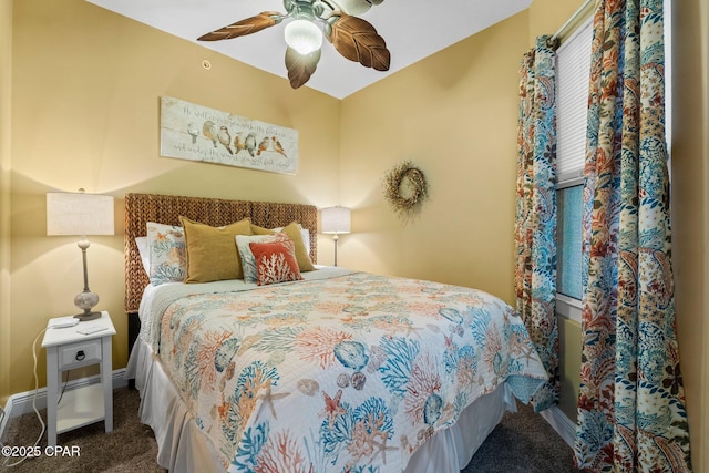 carpeted bedroom featuring baseboards and a ceiling fan