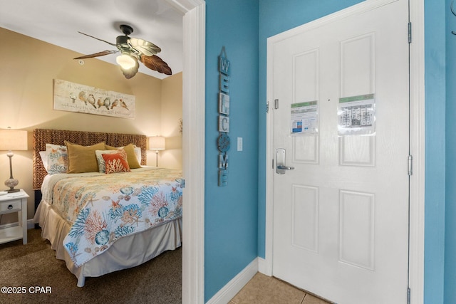 bedroom with light carpet, baseboards, and ceiling fan