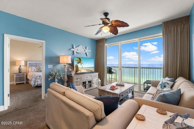living room featuring baseboards, carpet flooring, and ceiling fan