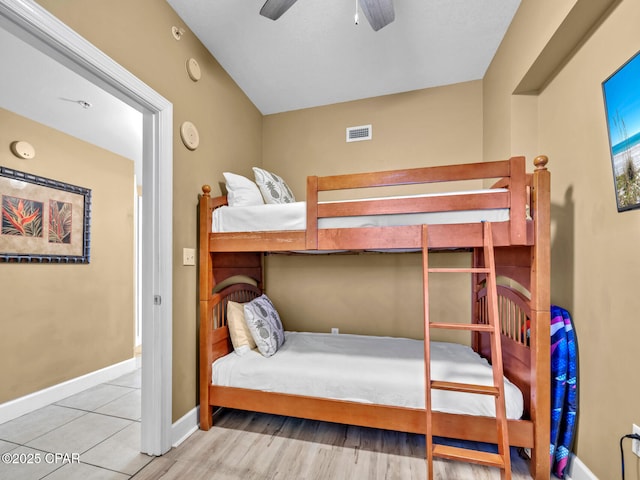 bedroom with ceiling fan, baseboards, and visible vents