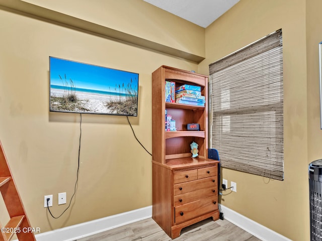 interior space featuring light wood-style flooring and baseboards
