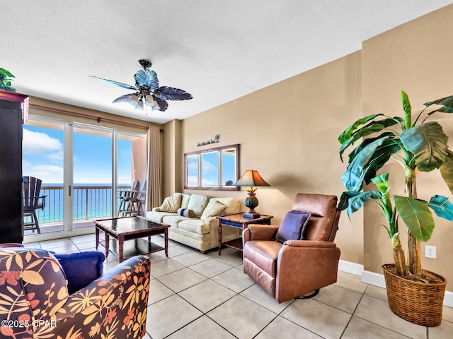 living area featuring a water view, plenty of natural light, and light tile patterned floors