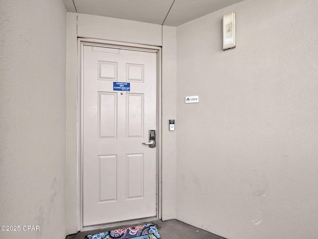 property entrance featuring stucco siding