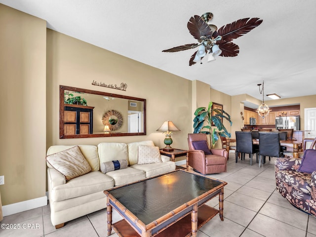 living area with light tile patterned flooring, baseboards, and a ceiling fan