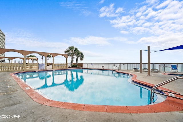 pool featuring a patio area and fence