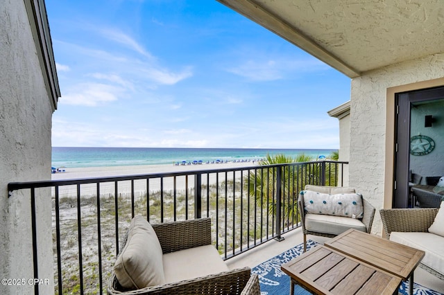 balcony featuring view of water and beach