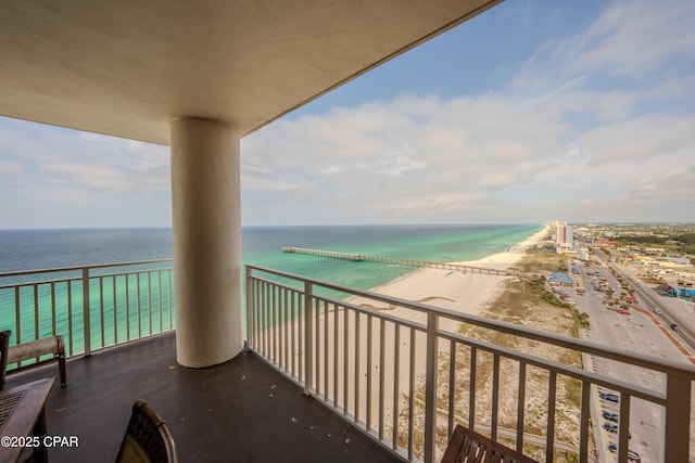 balcony with a water view and a beach view
