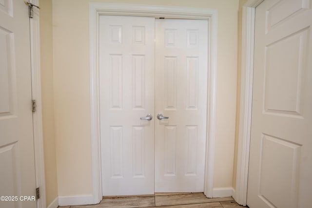 interior space with baseboards and wood finished floors