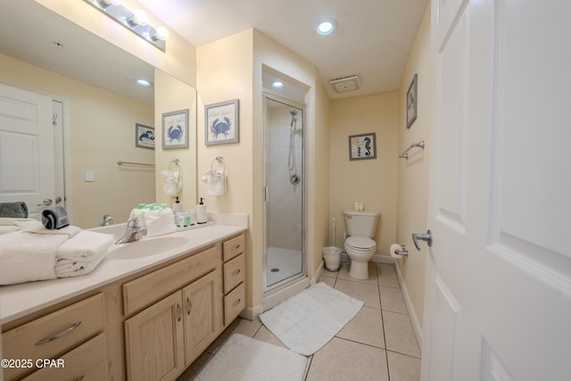 bathroom with toilet, a stall shower, tile patterned flooring, vanity, and recessed lighting