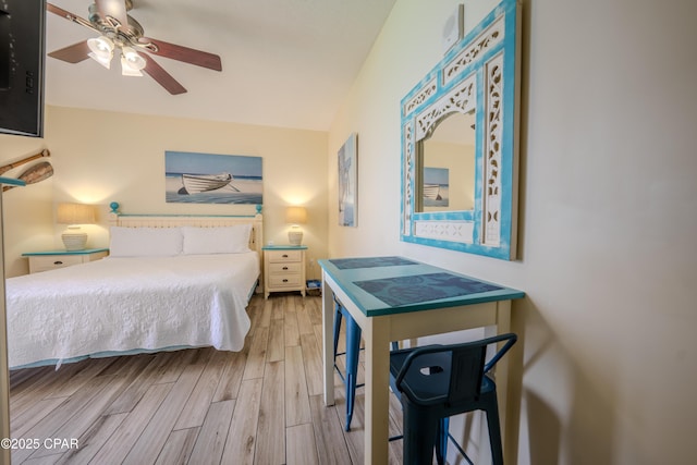 bedroom featuring ceiling fan, lofted ceiling, and wood finished floors