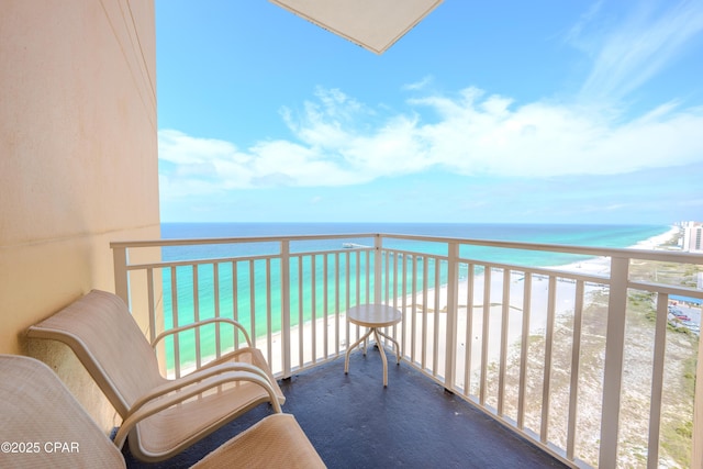 balcony featuring a water view and a view of the beach