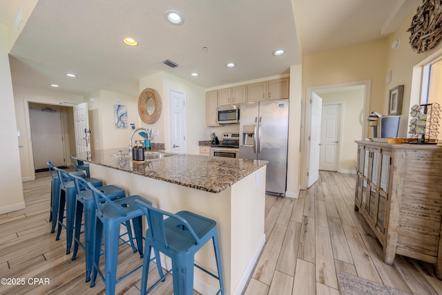 kitchen with a sink, light wood-style flooring, visible vents, and appliances with stainless steel finishes