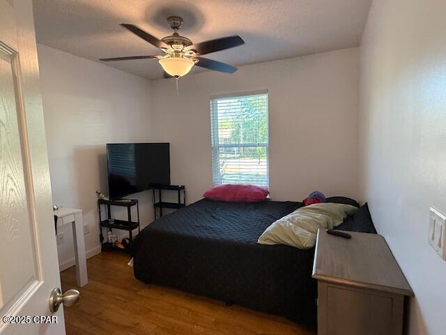 25 Wood Ave, Panama City, FL 32404 - bedroom with a ceiling fan and wood finished floors