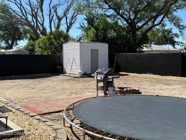 25 Wood Ave, Panama City, FL 32404 - view of patio featuring a grill, an outdoor structure, a storage shed, and fence