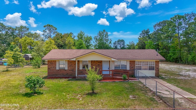 215 Tates Ln, Southport, FL 32409 - view of front of house with fence, a front lawn, a shingled roof, a porch, and brick siding