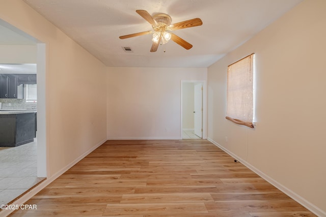 215 Tates Ln, Southport, FL 32409 - empty room with ceiling fan, light wood-style flooring, baseboards, and visible vents