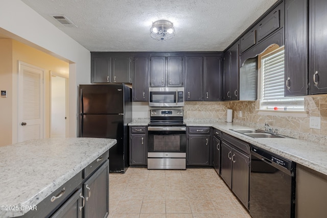 215 Tates Ln, Southport, FL 32409 - kitchen with a sink, a textured ceiling, black appliances, visible vents, and decorative backsplash