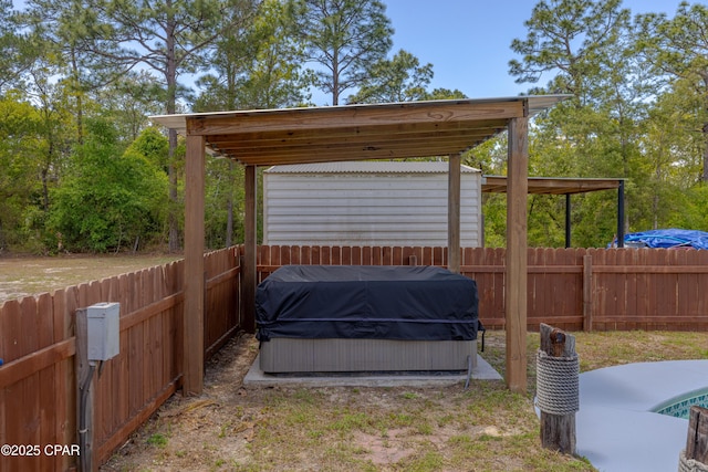 215 Tates Ln, Southport, FL 32409 - view of patio with a hot tub, a fenced backyard, and a grill