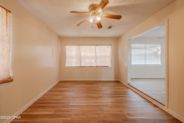215 Tates Ln, Southport, FL 32409 - empty room with light wood-style flooring, plenty of natural light, and visible vents