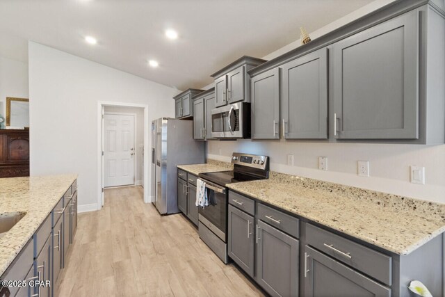 4717 Maegans Ridge Rd, Panama City, FL 32404 - kitchen with light wood finished floors, appliances with stainless steel finishes, light stone counters, lofted ceiling, and recessed lighting