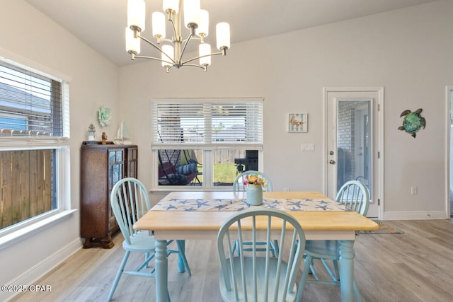4717 Maegans Ridge Rd, Panama City, FL 32404 - dining area with light wood-type flooring, baseboards, and a notable chandelier