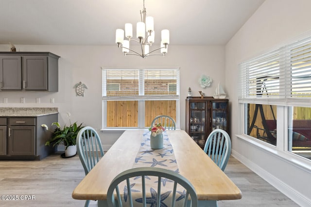 4717 Maegans Ridge Rd, Panama City, FL 32404 - dining area featuring baseboards, a notable chandelier, and light wood-type flooring
