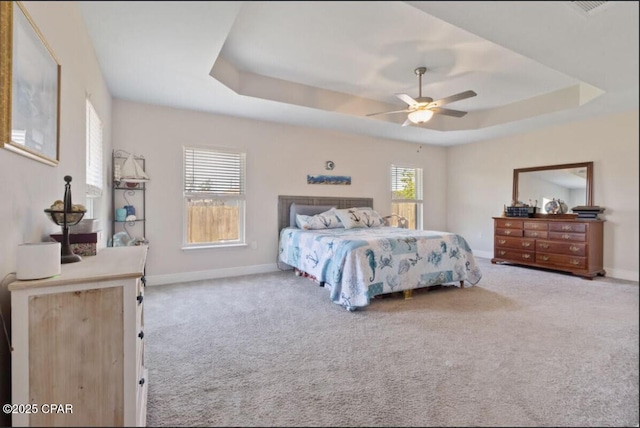 4717 Maegans Ridge Rd, Panama City, FL 32404 - carpeted bedroom with a tray ceiling, ceiling fan, and baseboards