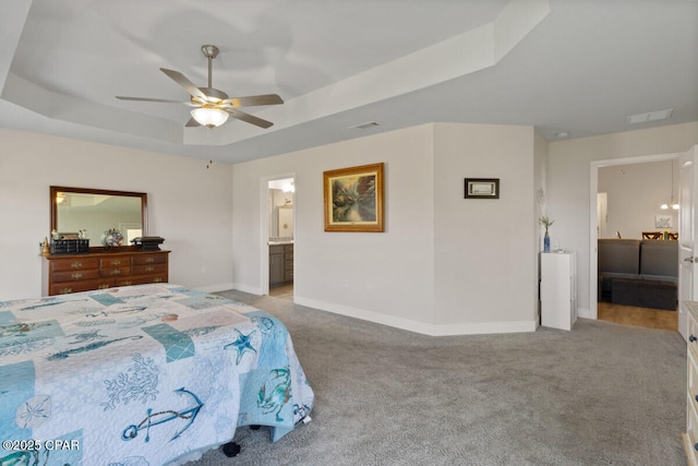 4717 Maegans Ridge Rd, Panama City, FL 32404 - bedroom with ensuite bathroom, carpet, visible vents, a tray ceiling, and baseboards