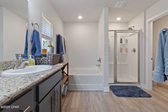 4717 Maegans Ridge Rd, Panama City, FL 32404 - bathroom with vanity, a garden tub, a shower stall, and wood finished floors