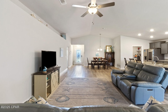 4717 Maegans Ridge Rd, Panama City, FL 32404 - living room featuring visible vents, vaulted ceiling, light wood-style flooring, a ceiling fan, and baseboards