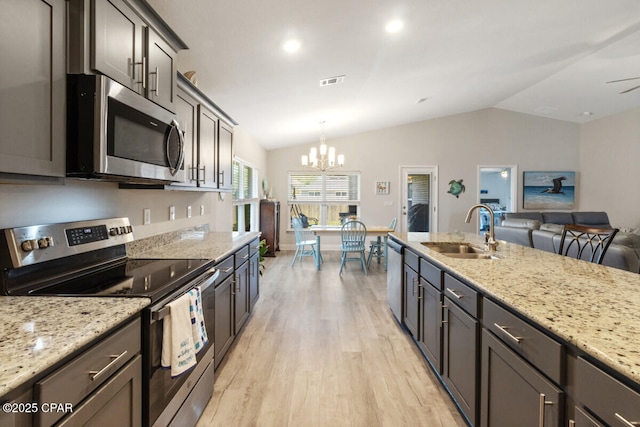 4717 Maegans Ridge Rd, Panama City, FL 32404 - kitchen featuring lofted ceiling, visible vents, a sink, stainless steel appliances, and light wood-type flooring