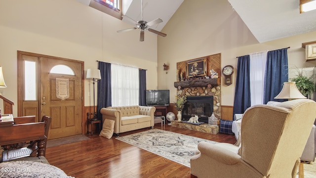 living room featuring a fireplace, a ceiling fan, high vaulted ceiling, and wood finished floors