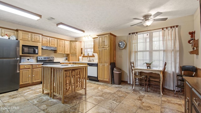 kitchen with a ceiling fan, light countertops, visible vents, and appliances with stainless steel finishes