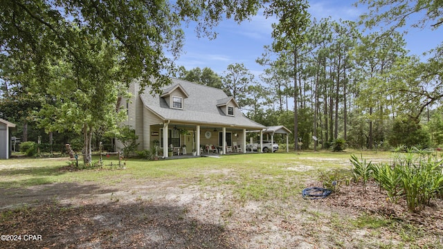 view of front of property featuring covered porch, a front yard, and ceiling fan