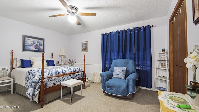 bedroom with carpet flooring, ceiling fan, and a textured ceiling