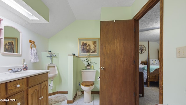 bathroom featuring toilet, lofted ceiling, a textured ceiling, tile patterned flooring, and vanity