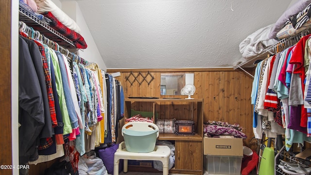 walk in closet featuring vaulted ceiling