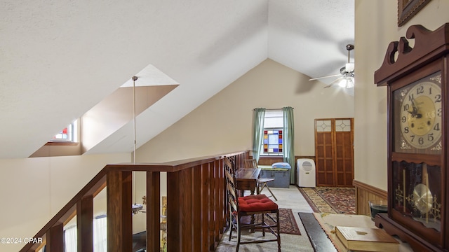 interior space with lofted ceiling and a wainscoted wall