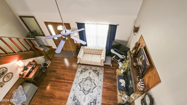 living area with a ceiling fan and wood finished floors