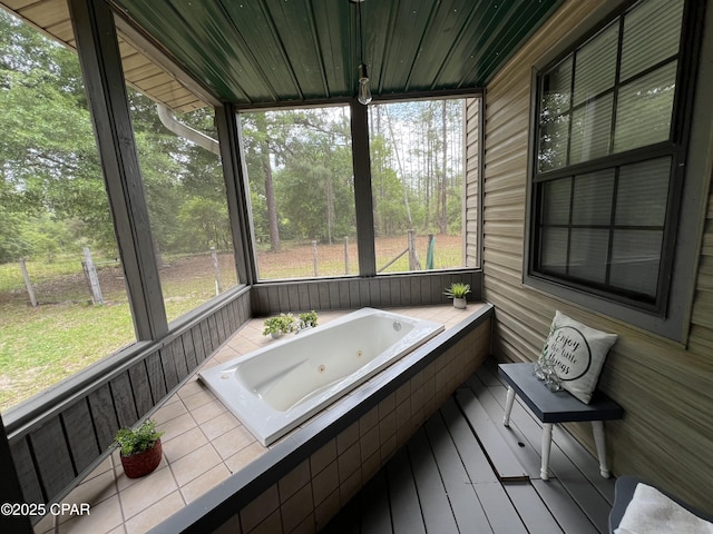 sunroom with a jacuzzi