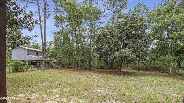 view of green lawn featuring stairs