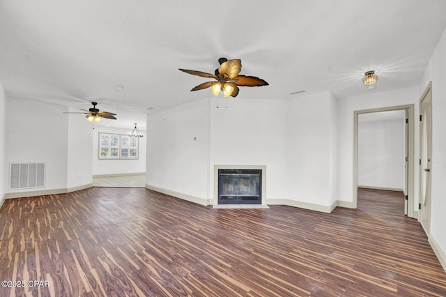 8508 S Holland Rd, Southport, FL 32409 - unfurnished living room with a ceiling fan, heating unit, wood finished floors, and a chandelier