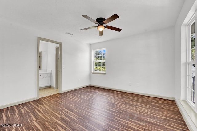 8508 S Holland Rd, Southport, FL 32409 - unfurnished room with light wood-style floors, ceiling fan, and baseboards